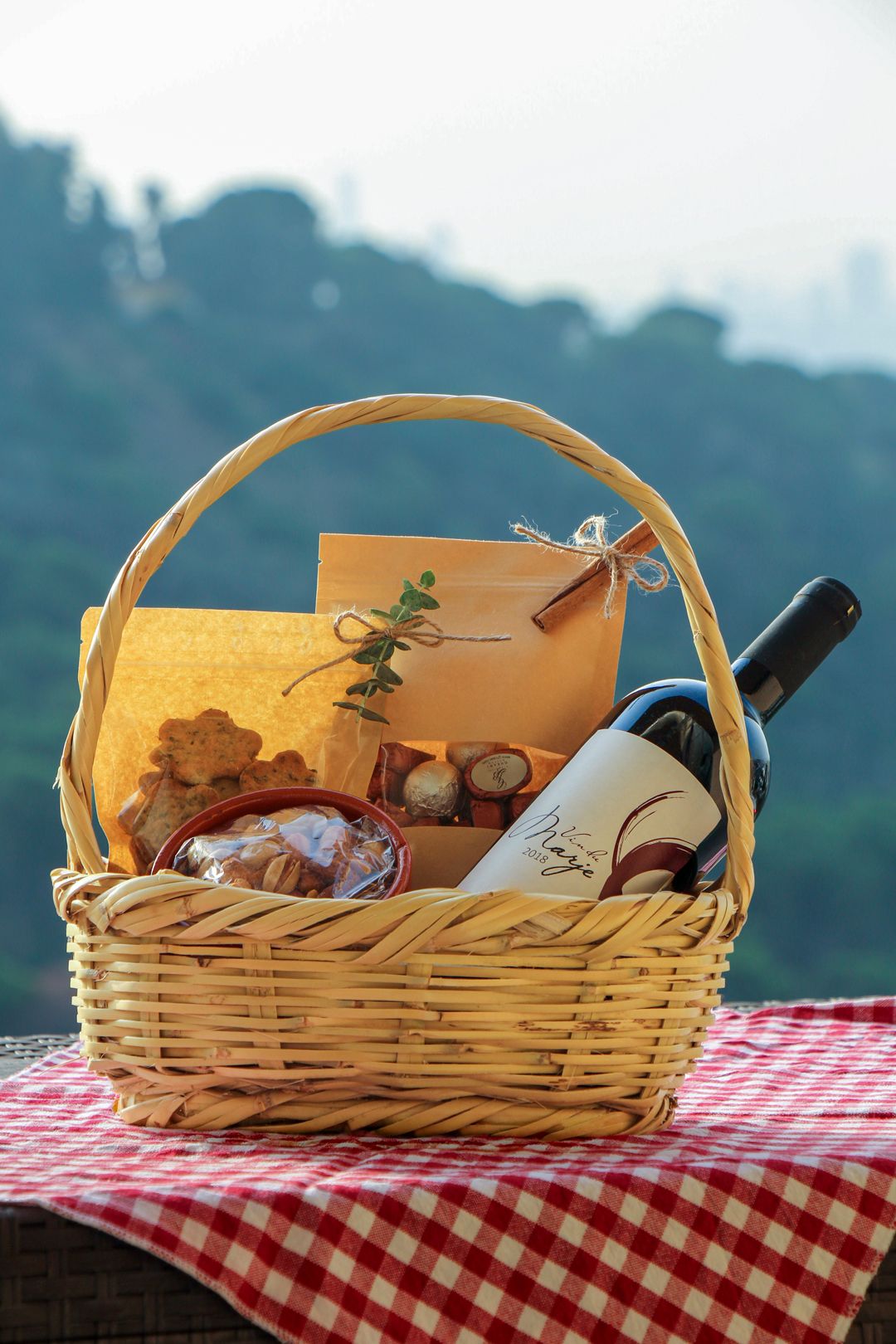 The Happy Hour basket: a bottle of 2018 Marjeyoun red, zaatar cookies, chocolates and salted nuts in a clay bowl